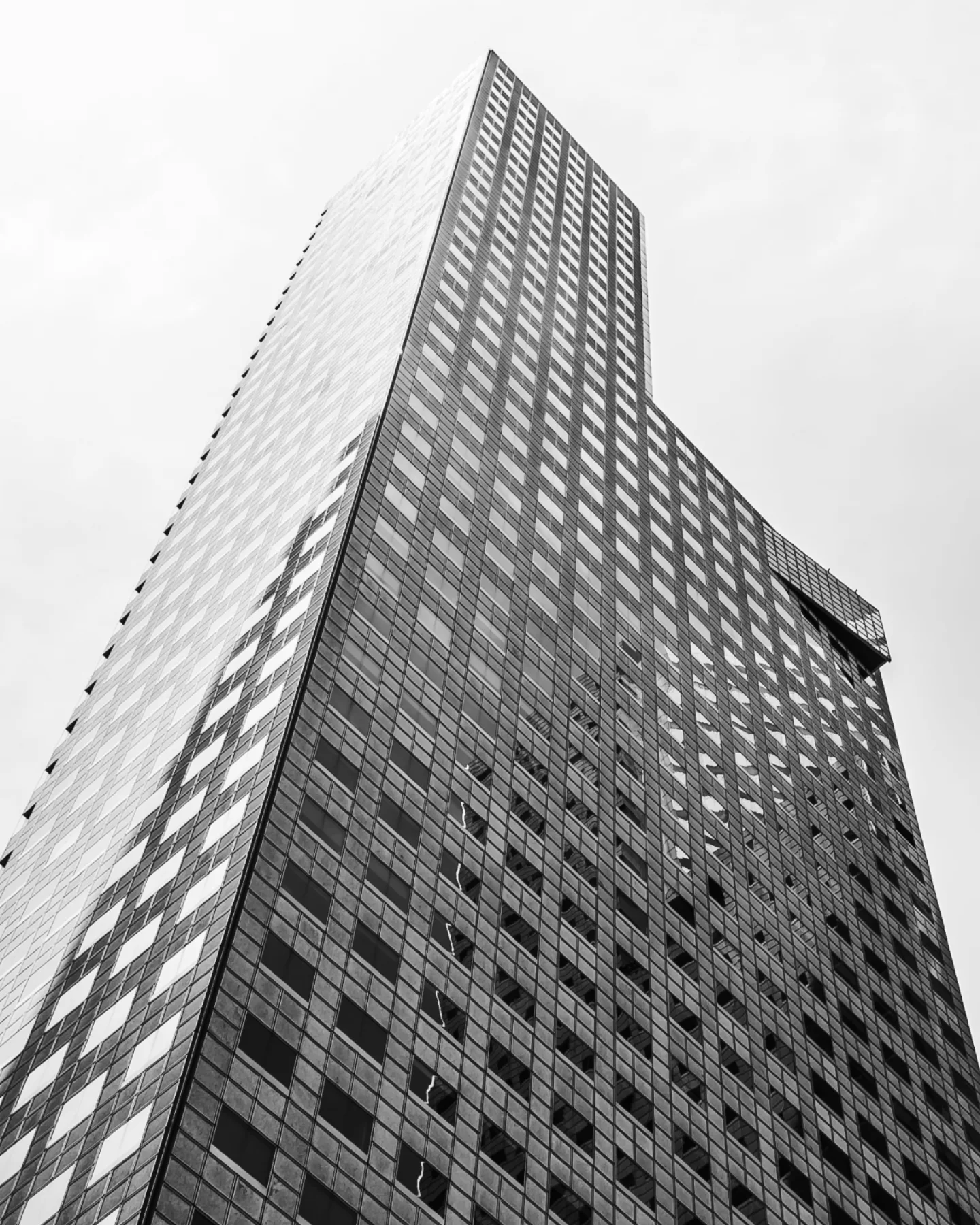 A concrete stair rising past an open oculus